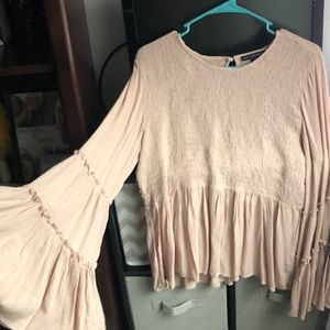 pink blouse with bell sleeves